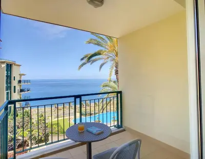 a balcony with a table and a view of the ocean at Vila Formosa Top View by LovelyStay in Funchal