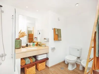 a bathroom with a toilet and a sink and a mirror at Lovely apartment with pool and sea view in Funchal