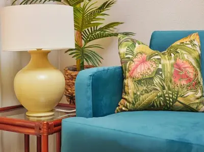 a blue chair with a pillow and a lamp on a table at Lovely apartment with pool and sea view in Funchal