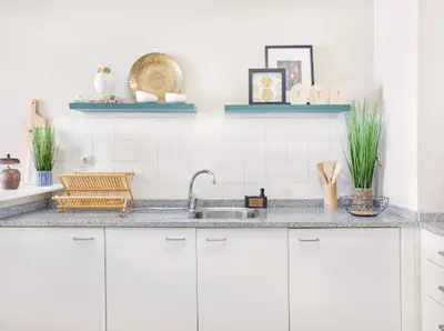 a kitchen with white cabinets and a sink at Lovely apartment with pool and sea view in Funchal