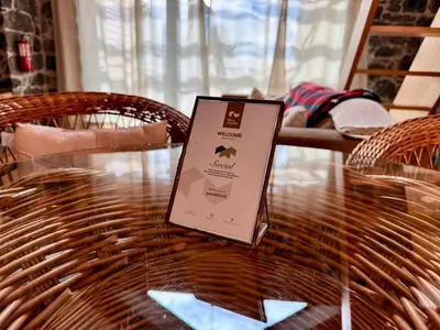 a laptop sitting on top of a wooden table at Palheiros do Serrado by Real Vision in Estreito da Calheta