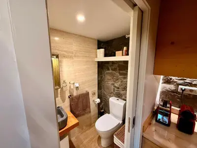 a small bathroom with a toilet and a sink at Palheiros do Serrado by Real Vision in Estreito da Calheta