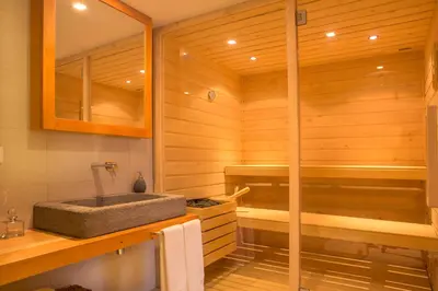 a bathroom with a sauna with a stone sink at Palheiros do Serrado by Real Vision in Estreito da Calheta