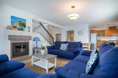 a living room with blue couches and a fireplace at Villa Estrella - Praia da Luz in Luz