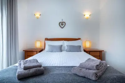 a bedroom with a bed with towels on it at Villa Estrella - Praia da Luz in Luz