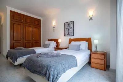 a bedroom with two beds and two night stands at Villa Estrella - Praia da Luz in Luz