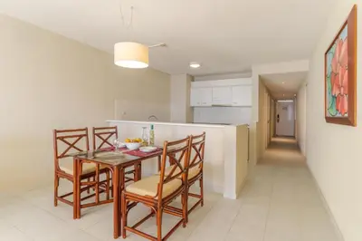 a kitchen and dining room with a table and chairs at Tranquil Beachside Stay - Atlantic Gardens Beach in Funchal
