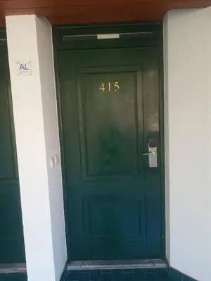 a green door with the number on it at Tranquil Beachside Stay - Atlantic Gardens Beach in Funchal