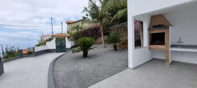 a balcony of a house with a fireplace at Villa Castanho I in Calheta