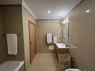 a bathroom with a sink and a toilet and a tub at Fairway 3 Apartment - Boavista Golf & Spa Resort in Lagos