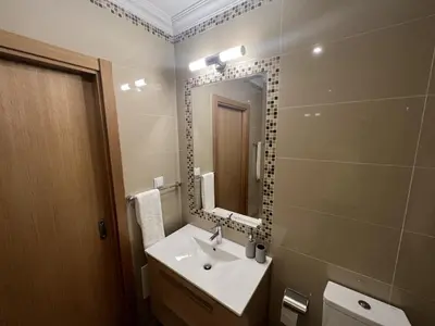 a bathroom with a sink and a mirror at Fairway 3 Apartment - Boavista Golf & Spa Resort in Lagos