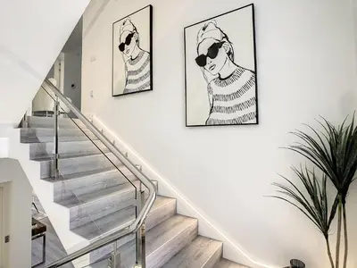 a staircase with two paintings of women on the wall at Wild River Villa by LovelyStay in Ribeira Brava