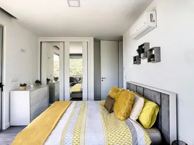 a bedroom with a large bed with yellow pillows at Wild River Villa by LovelyStay in Ribeira Brava