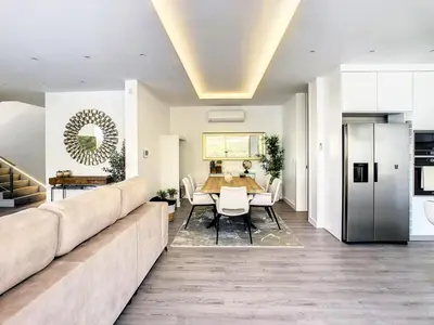 a living room with a large couch and a table at Wild River Villa by LovelyStay in Ribeira Brava
