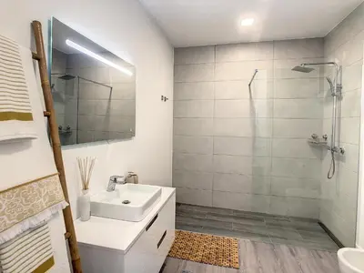 a white bathroom with a sink and a shower at Wild River Villa by LovelyStay in Ribeira Brava