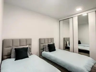 a bedroom with two beds and a mirror at Wild River Villa by LovelyStay in Ribeira Brava