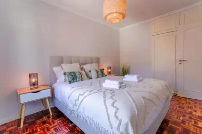 a bedroom with a bed with two lamps on it at MIO Apartment by Homie in Funchal