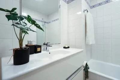 a bathroom with a sink and a potted plant at MIO Apartment by Homie in Funchal