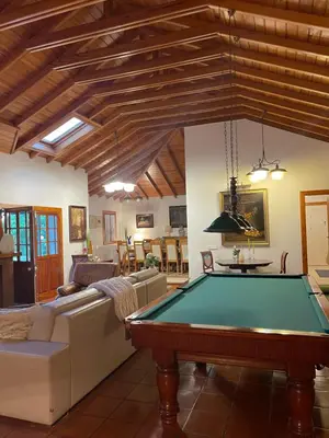 a living room with a bench and a painting on the wall at Casas de Pedra in Camacha