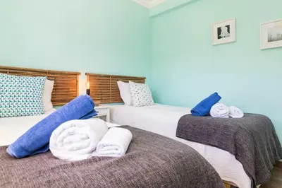 two beds in a room with towels on them at NEW beach flat with TOP VIEW - 3 min to sea in Luz in Luz