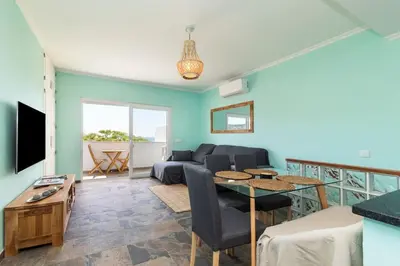 a living room with a couch and a table at NEW beach flat with TOP VIEW - 3 min to sea in Luz in Luz