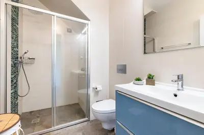 a bathroom with a toilet and a sink and a shower at NEW beach flat with TOP VIEW - 3 min to sea in Luz in Luz