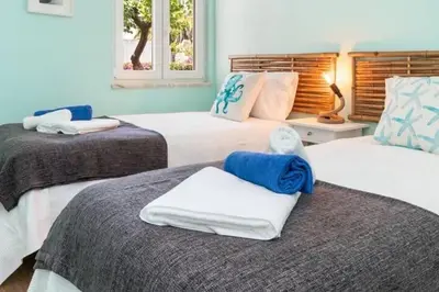 a bedroom with two beds with towels on them at NEW beach flat with TOP VIEW - 3 min to sea in Luz in Luz
