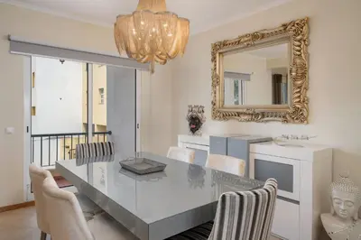 a dining room with a table and a mirror at Strategic Sunset House by An Island Apart in Santa Cruz