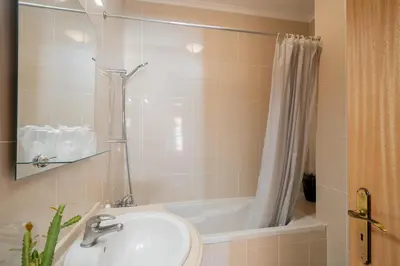 a bathroom with a sink and a shower and a tub at Strategic Sunset House by An Island Apart in Santa Cruz