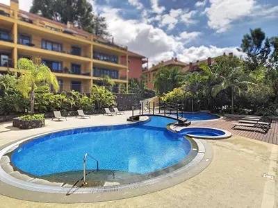 a large swimming pool in front of a building at Arigato Apartment by LovelyStay in Funchal