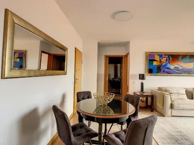 a living room with a table and chairs and a mirror at Arigato Apartment by LovelyStay in Funchal