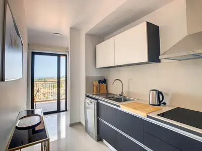 a kitchen with a sink and a counter top at Arigato Apartment by LovelyStay in Funchal