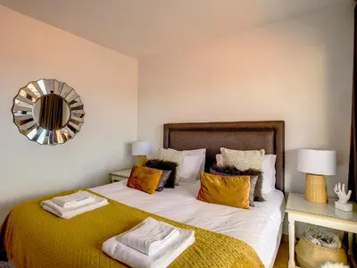 a bedroom with a bed and a mirror on the wall at Arigato Apartment by LovelyStay in Funchal