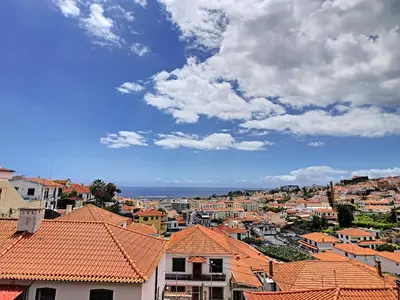 a view of a city with orange roofs at Arigato Apartment by LovelyStay in Funchal