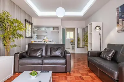 a living room with two leather couches and a table at Canico Sea Garden by Homie in Caniço