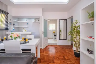a kitchen and living room with a table and chairs at Canico Sea Garden by Homie in Caniço