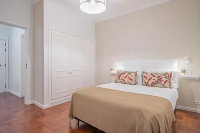 a white bedroom with a bed with pillows on it at Canico Sea Garden by Homie in Caniço