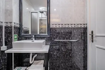 a bathroom with a sink and a mirror at Canico Sea Garden by Homie in Caniço