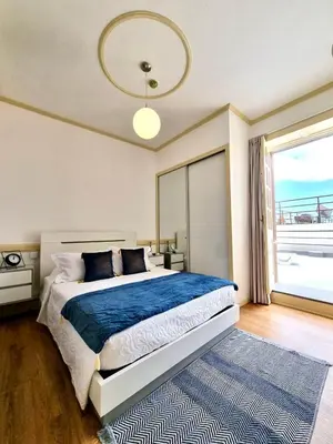 a bedroom with a large bed and a large window at Carreira Apartments Harbour View Free Parking in Heart Funchal in Funchal