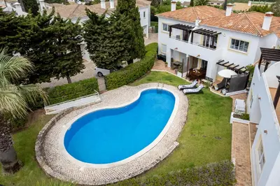 an aerial view of a house with a swimming pool at CoolHouses Luz, 3 Bed linked house, shared pool, a stone's throw of the sea, Casa Sirrah in Luz