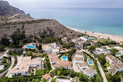 an aerial view of a house on the beach at CoolHouses Luz, 3 Bed linked house, shared pool, a stone's throw of the sea, Casa Sirrah in Luz