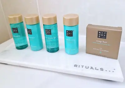 four bottles of hair products on a shelf next to a box at Casa Oceanis in Salema