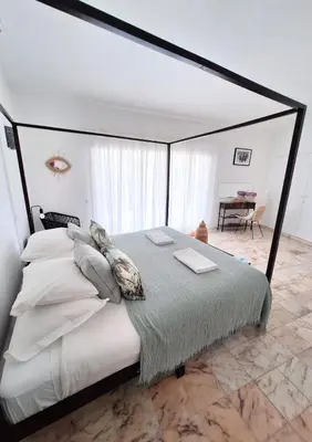 a bedroom with a large bed with a black frame at Casa Oceanis in Salema