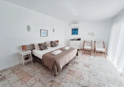 a bedroom with a bed and a table and a chair at Casa Oceanis in Salema