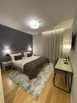 a bedroom with a large bed and a couch at PIER HOUSE Accommodation in Funchal