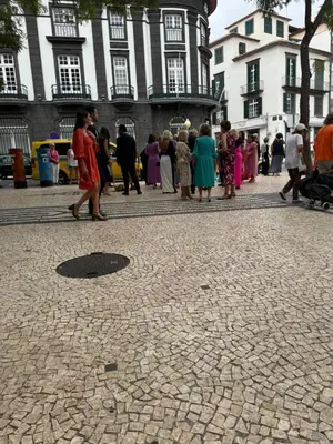 a group of people walking on a cobblestone street at PIER HOUSE Accommodation in Funchal