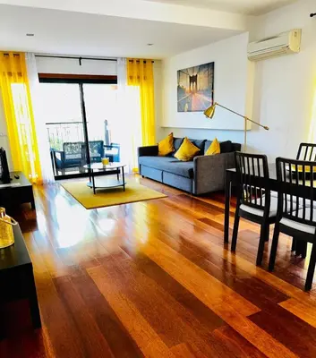 a living room with a couch and a table at Sunny Retreat in Luz