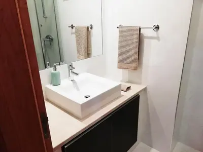a bathroom with a white sink and a mirror at Sunny Retreat in Luz
