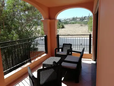 a balcony with chairs and a table and a view at Sunny Retreat in Luz