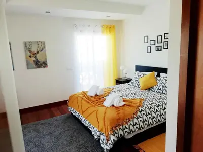 a bedroom with a bed with two towels on it at Sunny Retreat in Luz